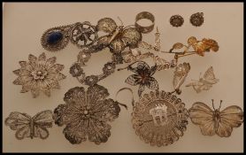 A selection of ornate filigree metal jewellery to include a floral spacer bracelet with safety chain