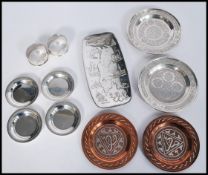 A pair of silver hallmarked napkin rings along with a group of three Persian silver peanut dishes