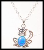 A silver pendant necklace in the form of cat set with an opal to the centre. Weight 3.4g. Chain