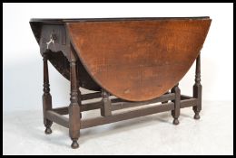 An 18th Century and later oval gate leg dining table, fitted with a single end drawer, on block