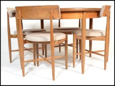 A set of 4 teak G-plan dining chairs designed by Koford Larsen. Raised on tapered turned legs with