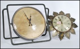 Two vintage clocks to include a Metamec sunburst wall clock and another large clock on tubular