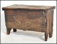 A small 17th / early 18th century country oak coffer chest of small proportions being raised on