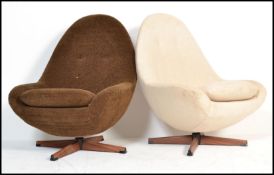 A pair of retro 20th Century swivel  egg chairs in the manner of Greaves and Thomas, one chair