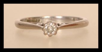 A hallmarked 18ct white gold diamond solitaire ring having a central prong set diamond with open