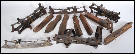 A collection of antique ice skates dating from the 19th Century, many constructed from steel and