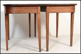 A 19th century Georgian mahogany dining table / pair of d-end console tables. Each raised on squared