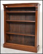 An Edwardian mahogany open window library bookcase being raised on a plinth base with shelves to