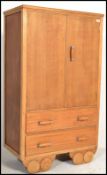 A vintage 20th Century Art Deco oak tallboy, upper doors raised over a bank of two long drawers,