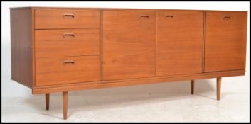 A vintage / retro 20th Century teak wood sideboard / Credenza, having an arrangement of  three