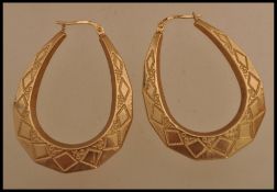 A pair of 9ct gold earrings having an engraved square design. Weighs 2.5 grams.