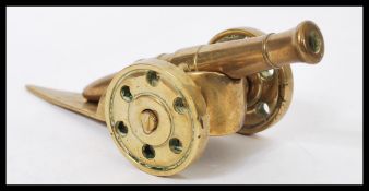 A vintage 20th century cast brass miniature Trench art type desk cannon of typical form.Measures