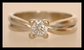 An Italian hallmarked 18ct white gold and diamond ring having a double band with central prong set