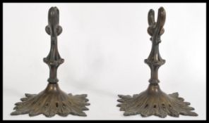 A pair of 19th century bronze scroll holders raise
