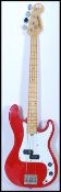 A vintage Marlin electric bass guitar having a red body with chrome tuning pegs. Measures 116cm long