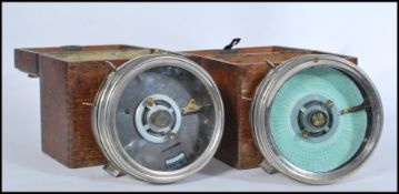 A pair of oak cased vintage 20th Century Pigeon clocks, both clocks housed in chrome cases, one with