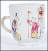 An 18th century Chinese porcelain teacup depicting traditional domestic scenes with gilt and ocher