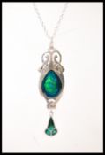A sterling silver Art Nouveau style pendant necklace in having a blue and green enamelled drop.
