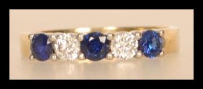 A hallmarked 18ct gold diamond and sapphire ring having alternating diamonds and sapphires. Approx