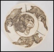 A 19th century Chinese ivory roundel pot depicting decoration of monkeys. The lidded pot of circular