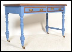 An early 20th century Edwardian painted mahogany writing table desk raised on turned and block