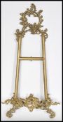 A 19th century Victorian gilt brass table stand / wall mounted picture holder of scrolled form.