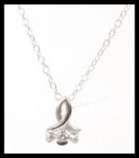 A stamped 925 silver chain necklace having a stamped 750 white gold pendant set with a brilliant cut