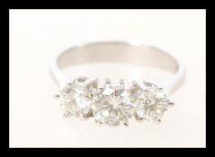 An 18ct white gold three stone diamond ring with prong set brilliant cut stones of approx 1.4cts.