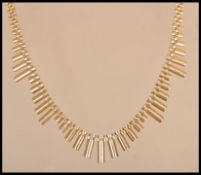 A hallmarked 9ct gold Cleopatra type necklace chain having a hidden clasp with scaling droplets.