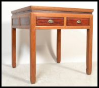 A 20th Century Chinese square lacquered hardwood centre table, the fretted and carved aprons with