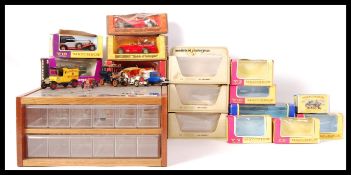 ASSORTED SCALE DIECAST MODEL CARS , BOXES AND DISPLAY CASE