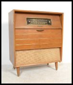 A retro mid century teak wood stereogram of square form being raised on shaped legs having an