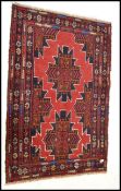 A vintage 20th Century Persian / Islamic woven woollen floor rug on blue ground decorated with