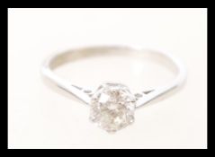 A stamped 750 18ct white gold diamond solitaire ring, prong set with a brilliant cut diamond.