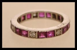 A white gold eternity ring set with square cut rubies and round cut diamonds. Size I.5. Weight 2.