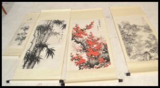 A group of four 20th century Japanese wood block prints on scrolls depicting traditional scenes with