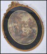 A 19th century coloured print of 'July' depicting a sheep shearer in an oval gilt floral moulded