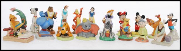 A selection of ceramic Disney character figurines to include Cinderella, Belle, Eyore, Simba, Dumbo,