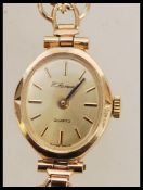 A ladies vintage 9ct gold cocktail watch by H. Samuel having an oval facet with baton markings to
