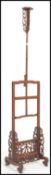 A vintage 20th century Chinese hardwood adjustable floor standing candlestick / lamp base having