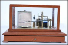 A vintage 20th century Barograph and Recorder by Gluck set on mahogany plinth base with glazed panel