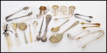 A collection of silver hallmarked and silver plated flatware to include three hallmarked napkin