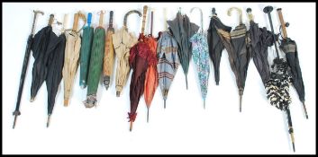 A very large collection of vintage early 20th century Edwardian umbrellas / parasols to include palm