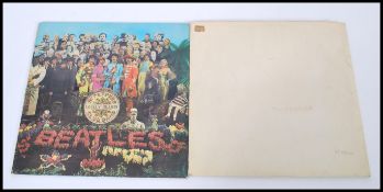 Two vintage early pressing Beatles Records comprising of The Beatles Sgt. Pepper's Lonely Hearts
