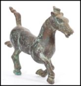 A 19th century Chinese bronze figurine of a Tang Dynasty style War Horse. 17cm high.