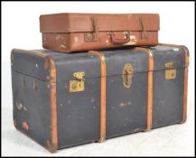 A vintage 20th Century canvas and cane bound steamer trunk, hinged top with latches to the front
