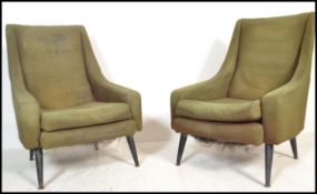 A  pair of retro 1960's armchairs in the manner of Greaves and Thomas, Raised on tapering ebonised