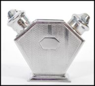 An vintage mid 20th century engine turned silver plated double pepperette having a slat and pepper