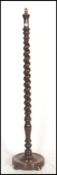 A 19th century Victorian mahogany barley twist standard lamp. Raised on a terraced base with tall