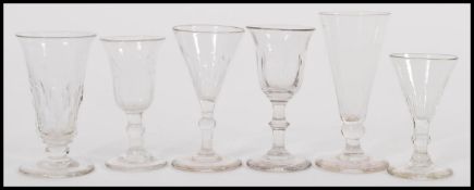 A harlequin set of small 19th Century rummer glasses to include some trumpet bowl examples with